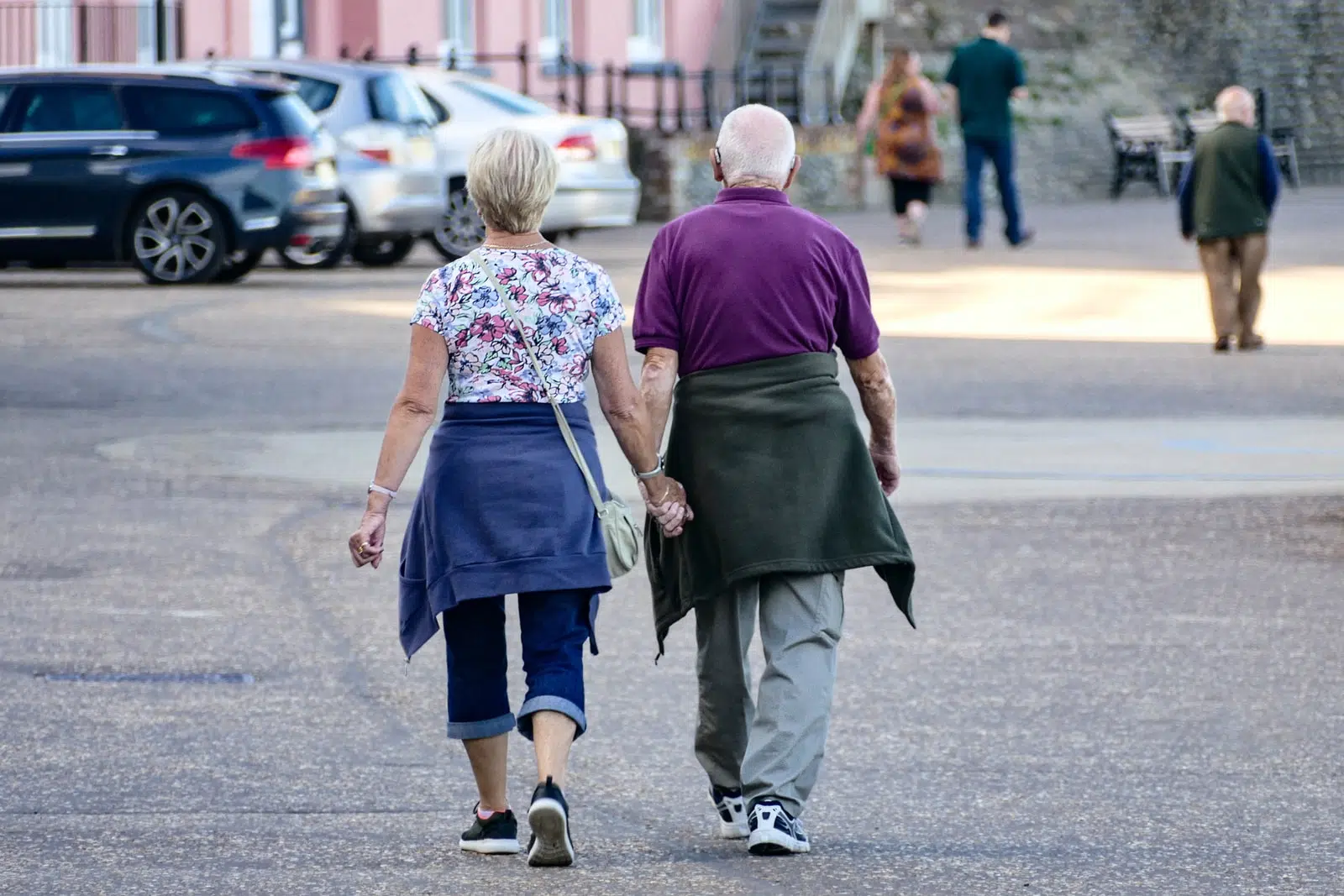 man and woman walking on the street during daytime