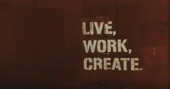 red brick wall with live, work, create. quote