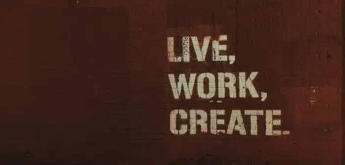 red brick wall with live, work, create. quote